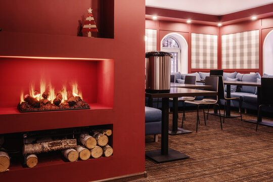 Electric fireplace and firewood in dining room of guest house
