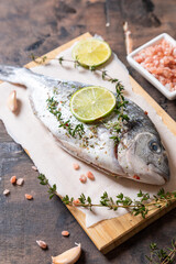 fresh raw dorado fish. dorado fish and cooking ingredients - lime, salt, oil, garlic, thyme and...