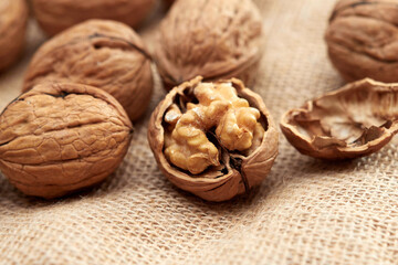 Close-up walnuts lie on a burlap.