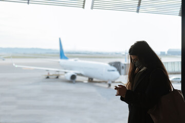 Young woman using smart phone at the airport