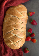 Appetizing sweet bread on a table. Homemade white wheat flour bread on gray textured background. 