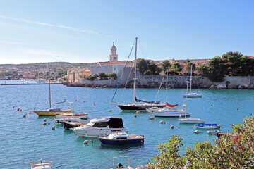 Picturesque old town of Krk on the Adriatic coast, boats on azure water on a sunny day, Krk island, Croatia