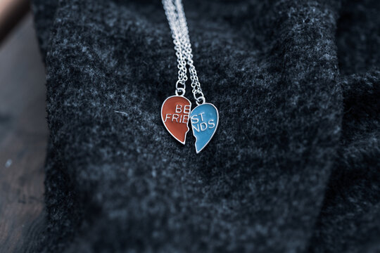 Pendant Set Of Best Friends Two Colors Heart Necklace Shoot Outside In A Summer Day Closeup. Selective Focus. High Quality Photo