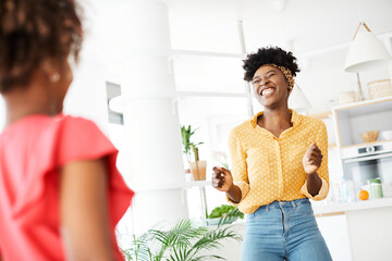 child daughter mother family happy playing kid childhood dancing parent home woman girl bonding fun cheerful