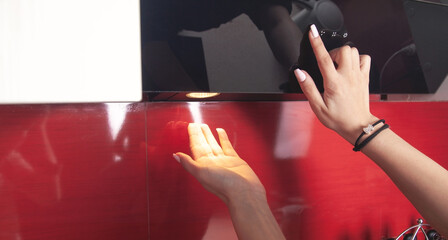 Female hand select program at modern cooking hood.