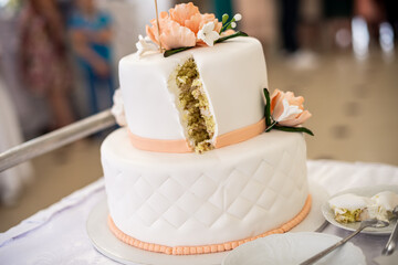 Beautiful wedding cake decorated with flowers, cake close up and blur background