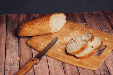 slicing a loaf on a wooden cutting board freshness breakfast