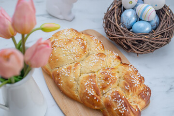 Sweet home made braided yeast bun for easter on a table