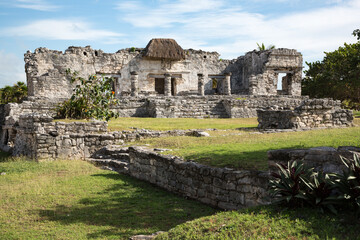 Mayan temple ruins with a thatched roof over a descending god fresco in Tulum, Quintana Roo, Yucatan peninsula, Mexico