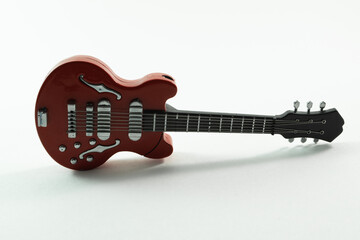 Toy guitar product photography, front view.