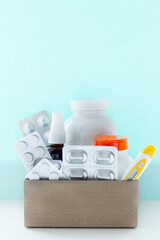 Image of a box of compounded prescription medications shipped from a mail order pharmacy on a lihgt blue background.