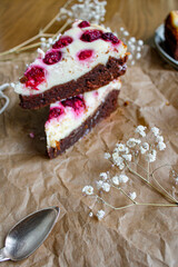 Raspberry cheesecake close up on set table with cup of coffee and flowers. 