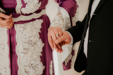 Fototapeta na wymiar bride and groom holding hands rings