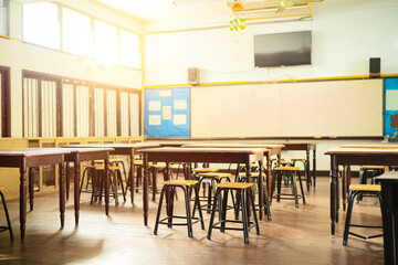 Lecture room or School empty classroom with desks and chair iron wood for studying lessons in high school thailand