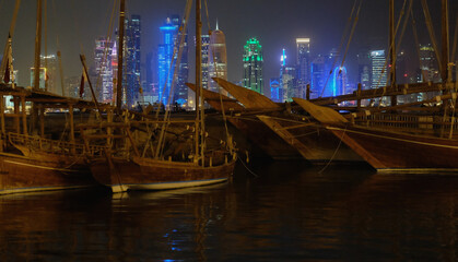 Boats and the skyline view of Doha, Qatar at the night