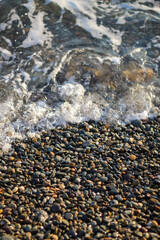 sea ​​pebbles and white evening waves.