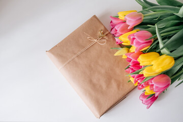 Fresh spring yellow and pink tulips bouquet on white wood table background with copy space for text. Love, easter, International Women day, Mother day and Happy Valentine day concept