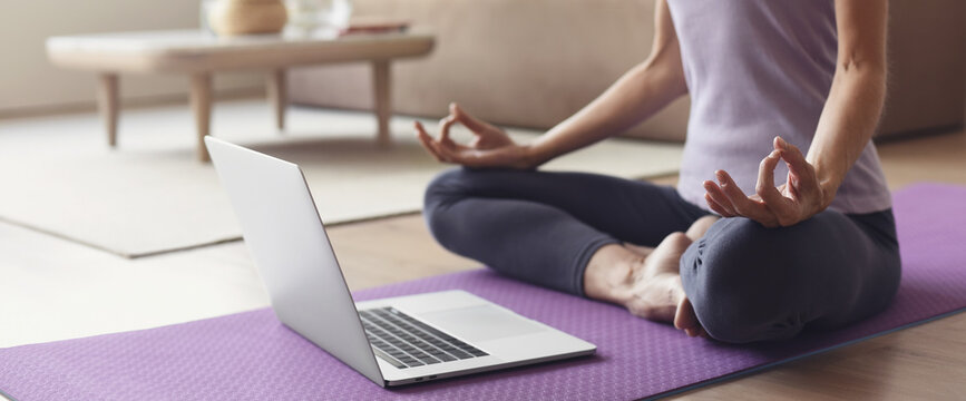 Young woman practicing yoga at home panoramic banner, online video training, Girl doing exercises and meditate, Yoga, balance, meditation, relaxation, healthy lifestyle, online training class concept
