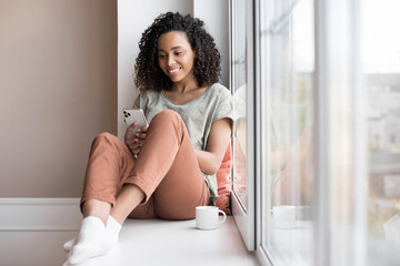 Young woman resting at home with smartphone, beautiful girl looking at phone panoramic banner,...