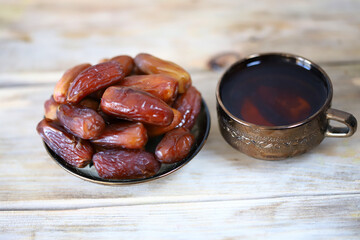 A cup of date tea. Dried dates. Arabic drink. Ramadan.