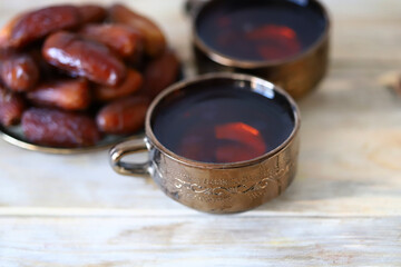 A cup of date tea. Dried dates. Arabic drink. Ramadan.