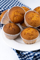 Biscuit muffins close-up. Sweet pastries. Party treat. Dessert on white table - homemade muffins. Portioned cupcakes. Simple muffin