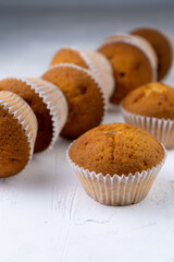 Biscuit muffins close-up. Sweet pastries. Party treat. Dessert on white table - homemade muffins. Portioned cupcakes. Simple muffin