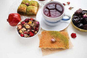 pomegranate tea in a teacup and oriental sweets