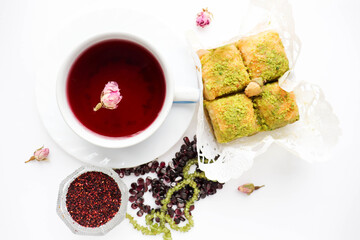 pomegranate tea in a teacup and oriental sweets