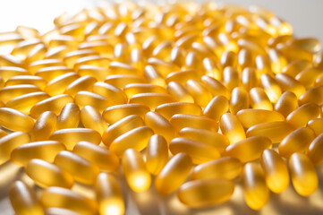 Close-up of golden omega three capsules. Dietary supplement fish oil