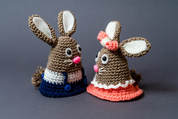 Homemade amigurumi egg warmers crocheted from wool. In different scenes with a white and gray...