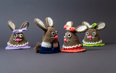 Homemade amigurumi egg warmers crocheted from wool. In different scenes with a white and gray...