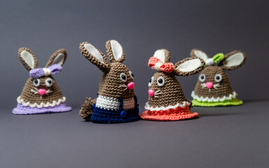 Homemade amigurumi egg warmers crocheted from wool. In different scenes with a white and gray background and on a dining table.