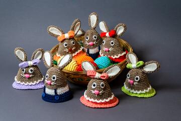 Homemade Amigurumi egg warmers crocheted from wool. In different scenes with a white and gray background and on a dining table.