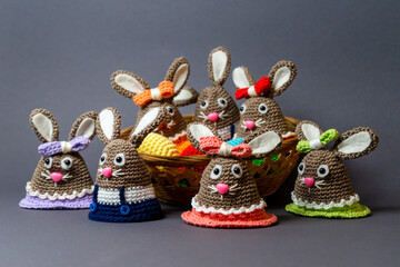 Homemade Amigurumi egg warmers crocheted from wool. In different scenes with a white and gray background and on a dining table.