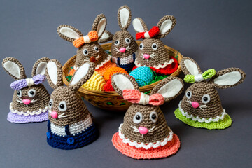 Homemade Amigurumi egg warmers crocheted from wool. In different scenes with a white and gray...
