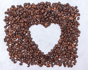 Heart coffee frame made of coffee beans on white stucco background, top view, copy space. Coffee love concept
