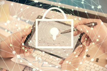 Multi exposure of man's hands holding and using a digital device and lock drawing. Security concept.