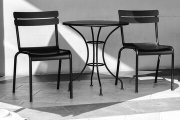 Black iron chairs and tables park in front of the mall pretty design black and white picture