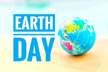 Earth day logo with global ball over blurred blue water background, environmental concept