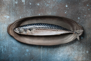 Fresh mackerel fish on ceramic plate