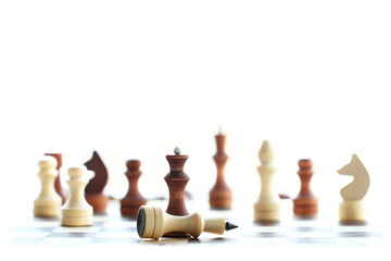 selective focus of chess wooden pieces on white background, black queen defeats white king, concept of success and goal achievement