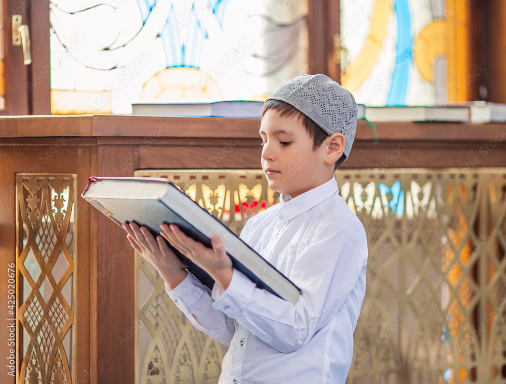 Wall mural little boy in the mosque read the quran