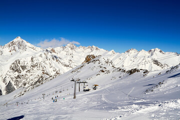 Fototapeta na wymiar Beautiful snowy mountains and blue sky Dombay Karachay-Cherkessia