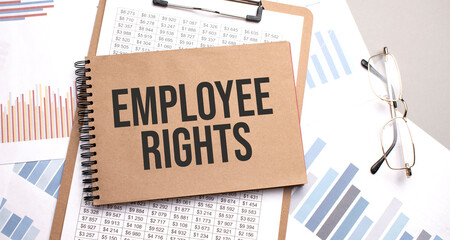 Notepad with text EMPLOYEE RIGHTS on a charts and numbers. Business concept.