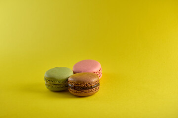 Cake macaron on yellow background flavor almond cookies pastel colors.