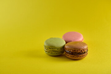Cake macaron on yellow background flavor almond cookies pastel colors.