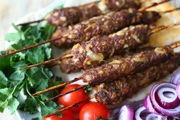 Selective focus. Kebab plate with vegetables, herbs and pita bread. Rabmadan concept. Arabic and Turkish traditional food.
