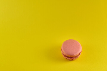Top view of cake macaron on yellow background flavor almond cookies pastel colors.