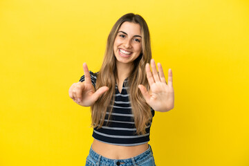 Young caucasian woman isolated on yellow background counting seven with fingers